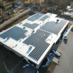 commercial building with solar electric panels on roof